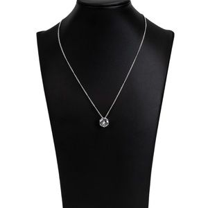 A single rhinestone sparkles brilliantly with earrings